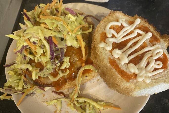 Buffalo chicken burger with coleslaw and kewpie mayo