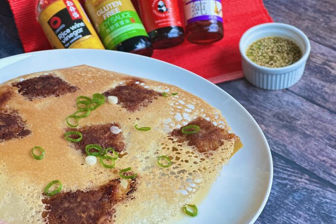 Dumplings with a crispy lace skirt and dipping sauce